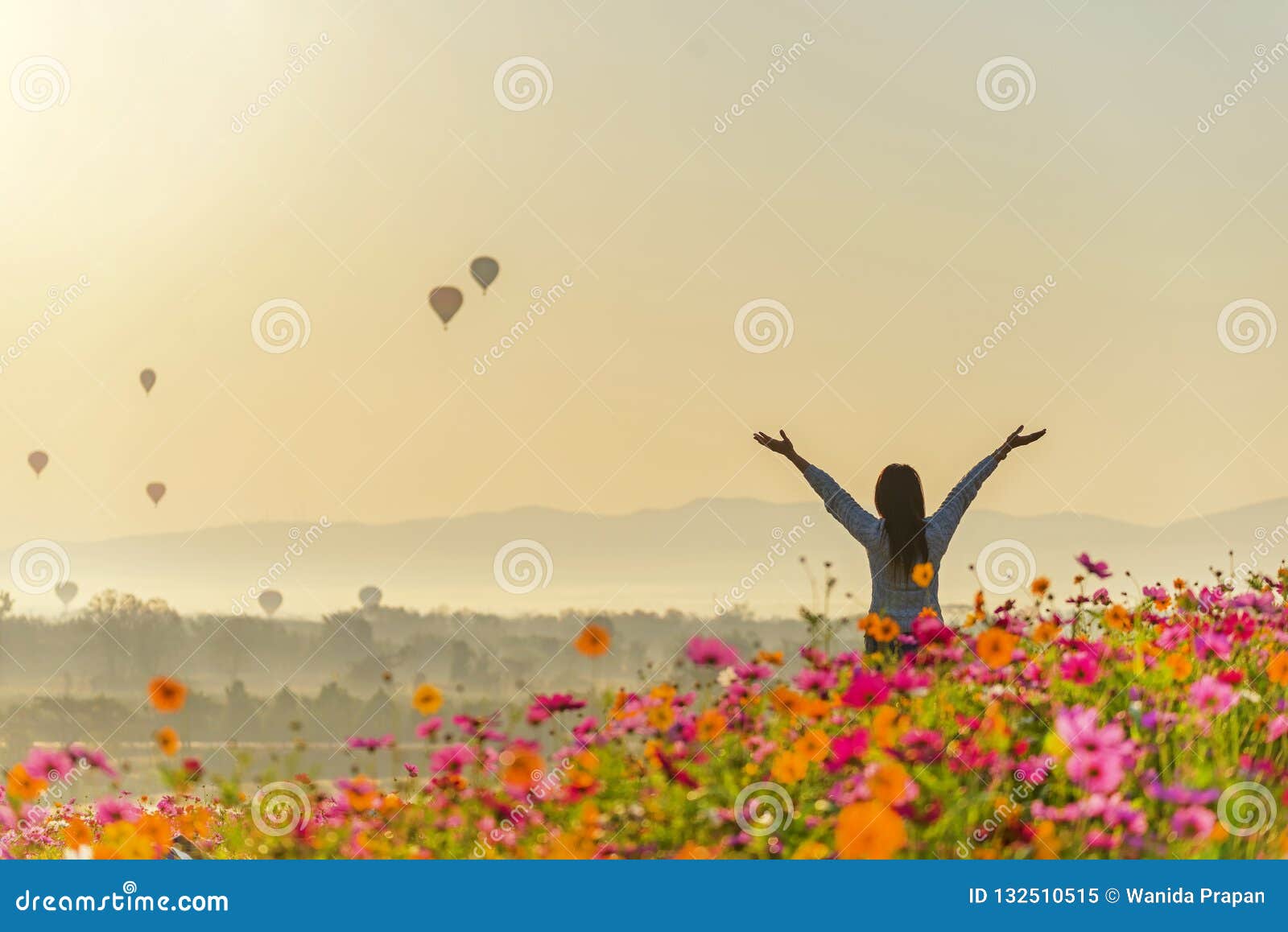 lifestyle traveler women raise hand feeling good relax and happy freedom and see the fire balloon