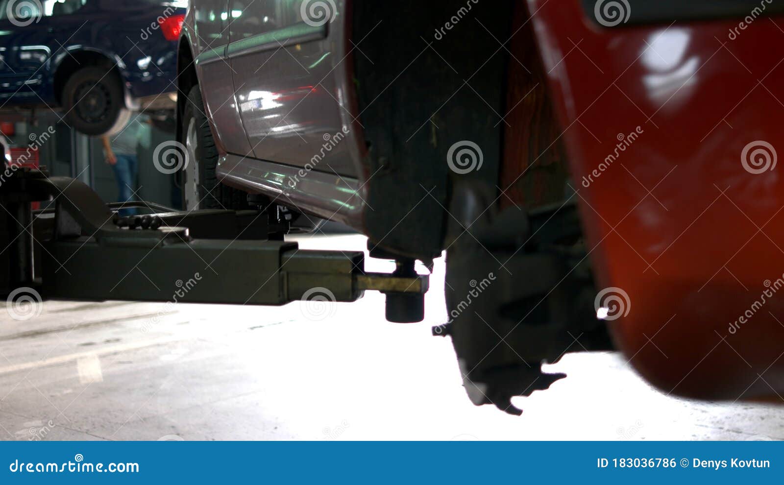 Lifted Red Car in a Car Service. Stock Photo Image of problem