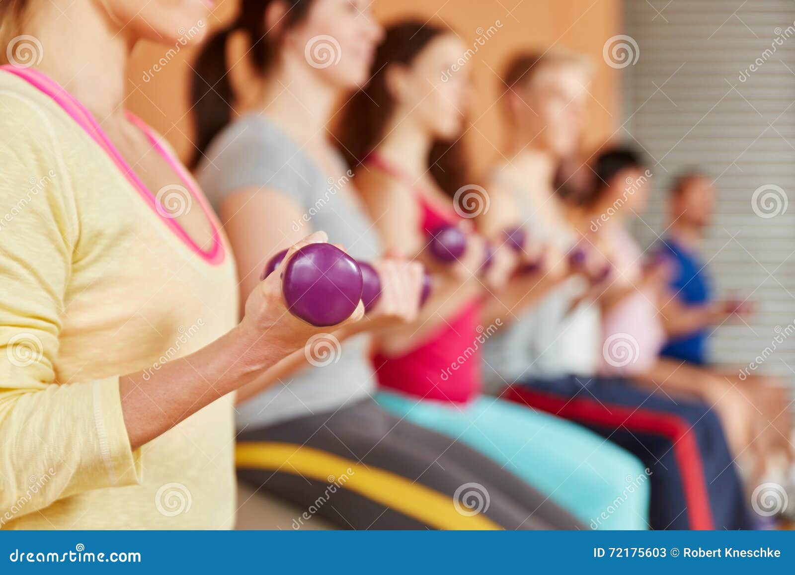 Lifting weights in a class stock image. Image of effort 72175603