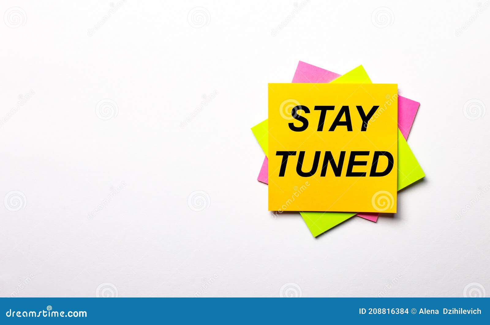 on a light background - bright multicolored stickers with the text stay tuned. copy space