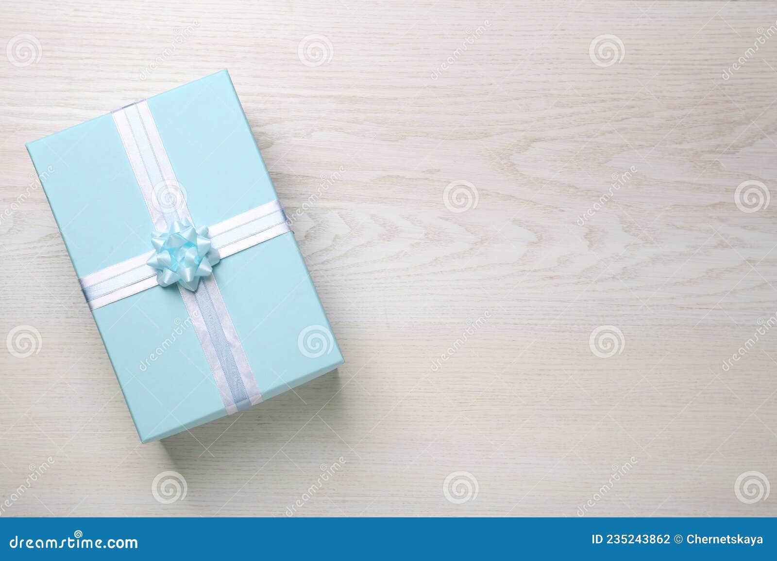 Light Blue Gift Box on White Wooden Table, Top View. Space for Text