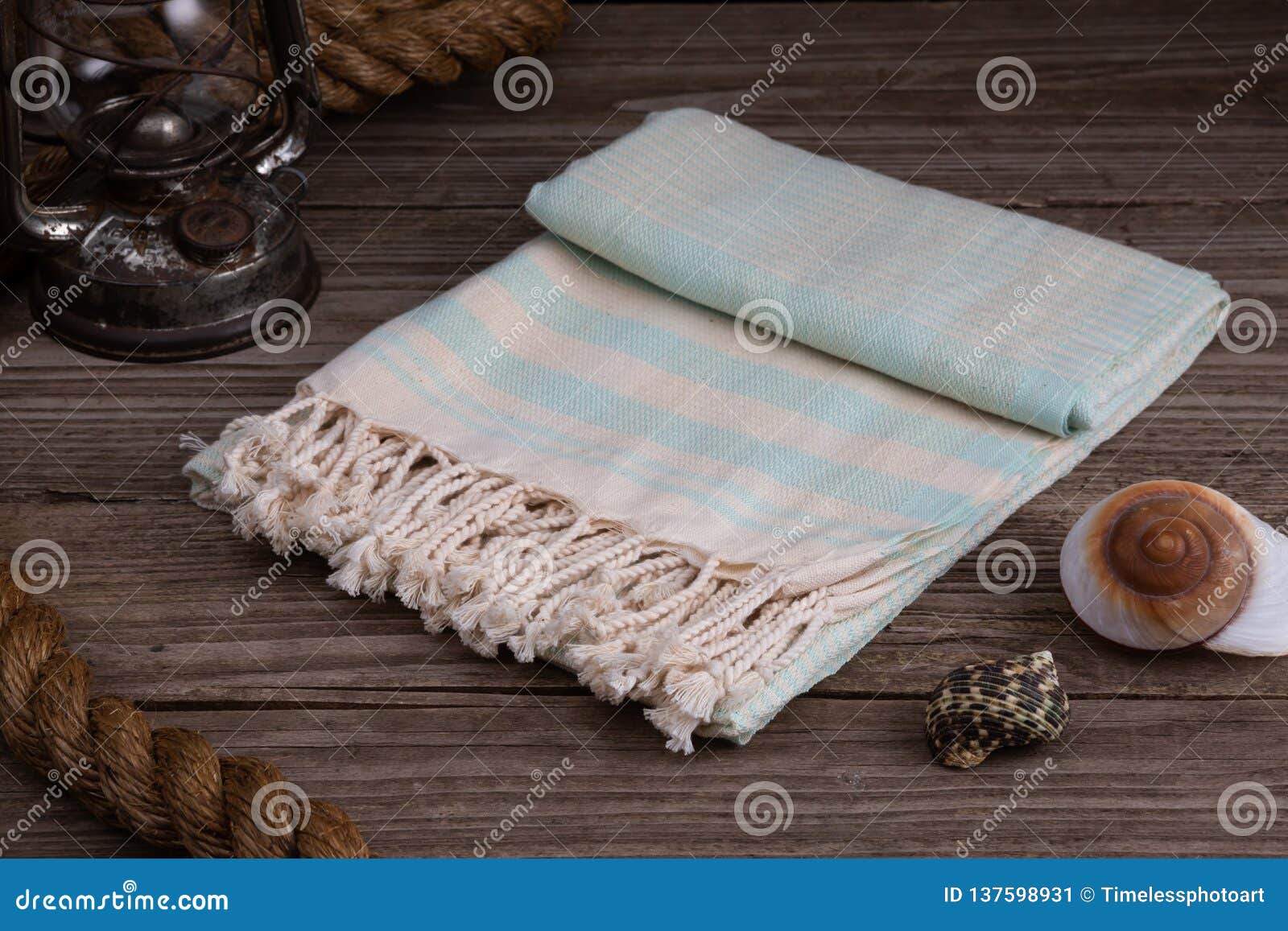 light blue handwoven hammam turkish cotton towel on rustic wooden background