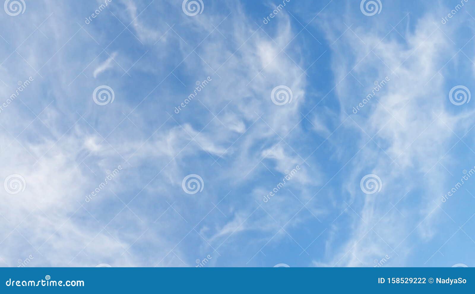 evenly distributed hazy clouds in light blue sky