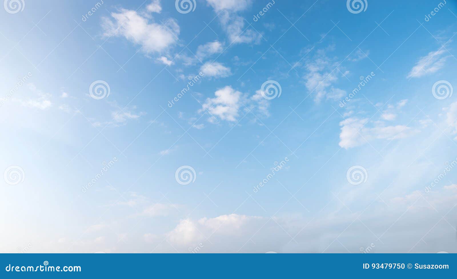 light blue sky with tiny fluffy clouds