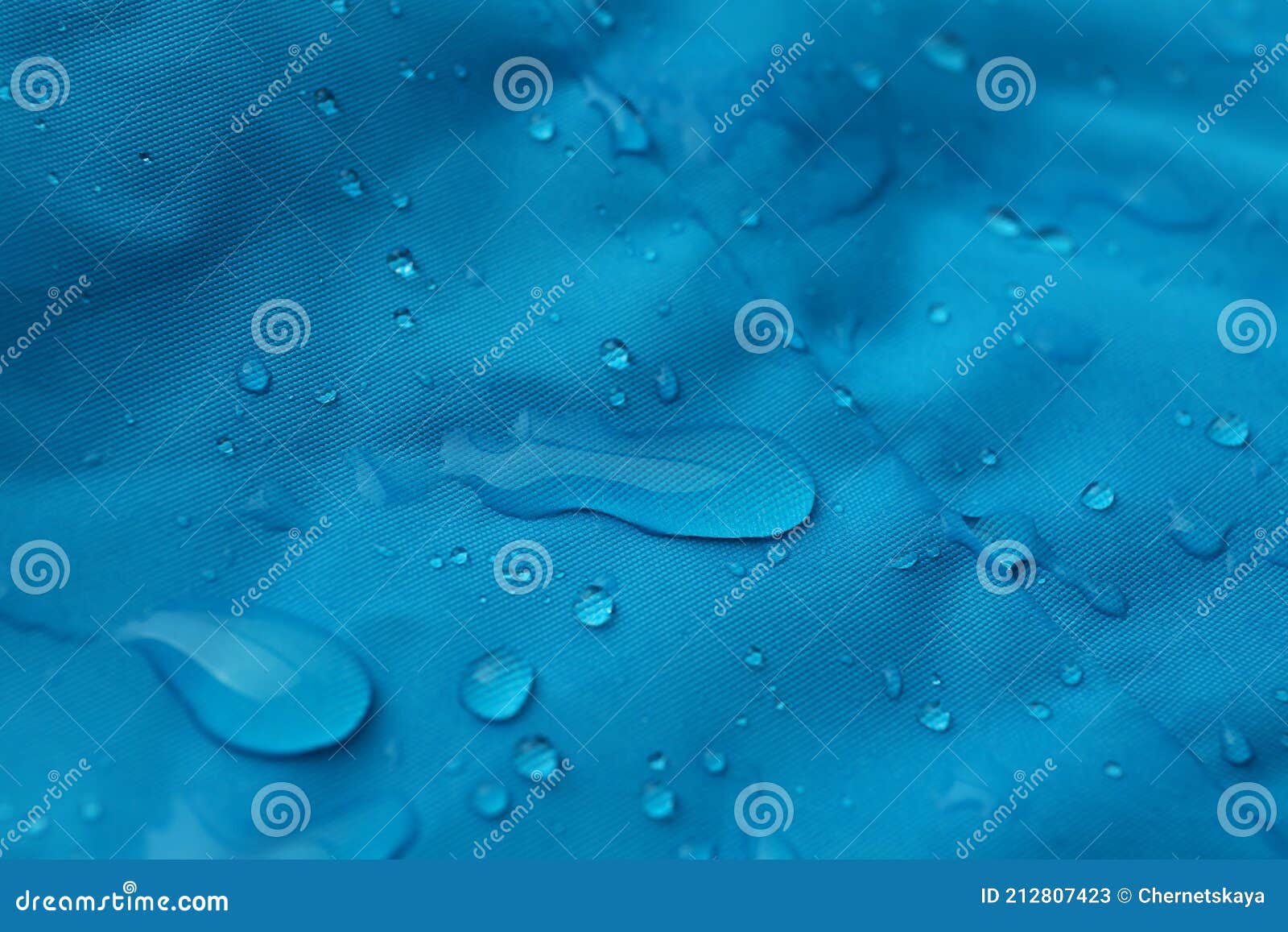Light Blue Waterproof Fabric with Water Drops As Background, Closeup