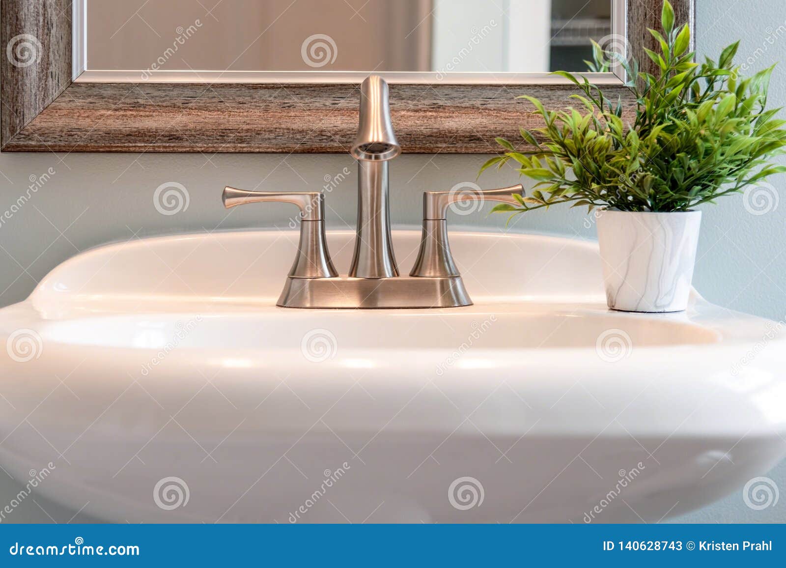 Light And Bright Closeup Of Bathroom Sink With Brushed Nickel