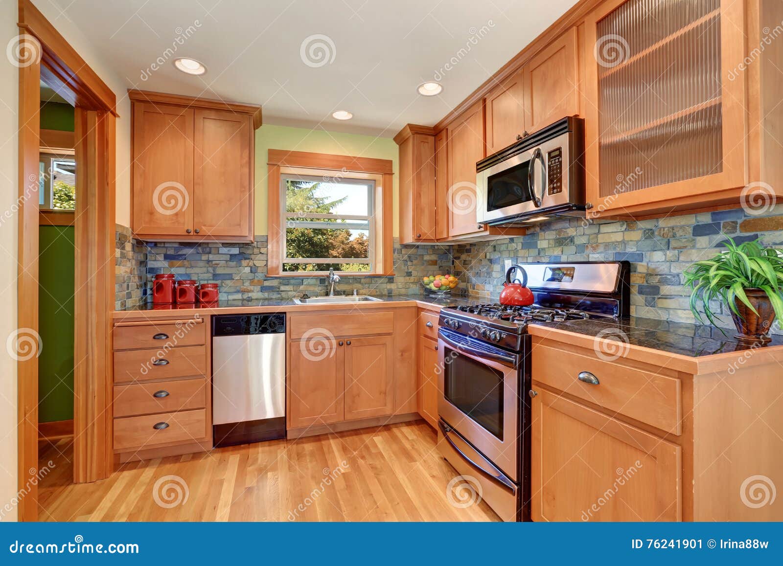 Light Brown Kitchen Cabinetry And Brick Tile Back Splash Trim