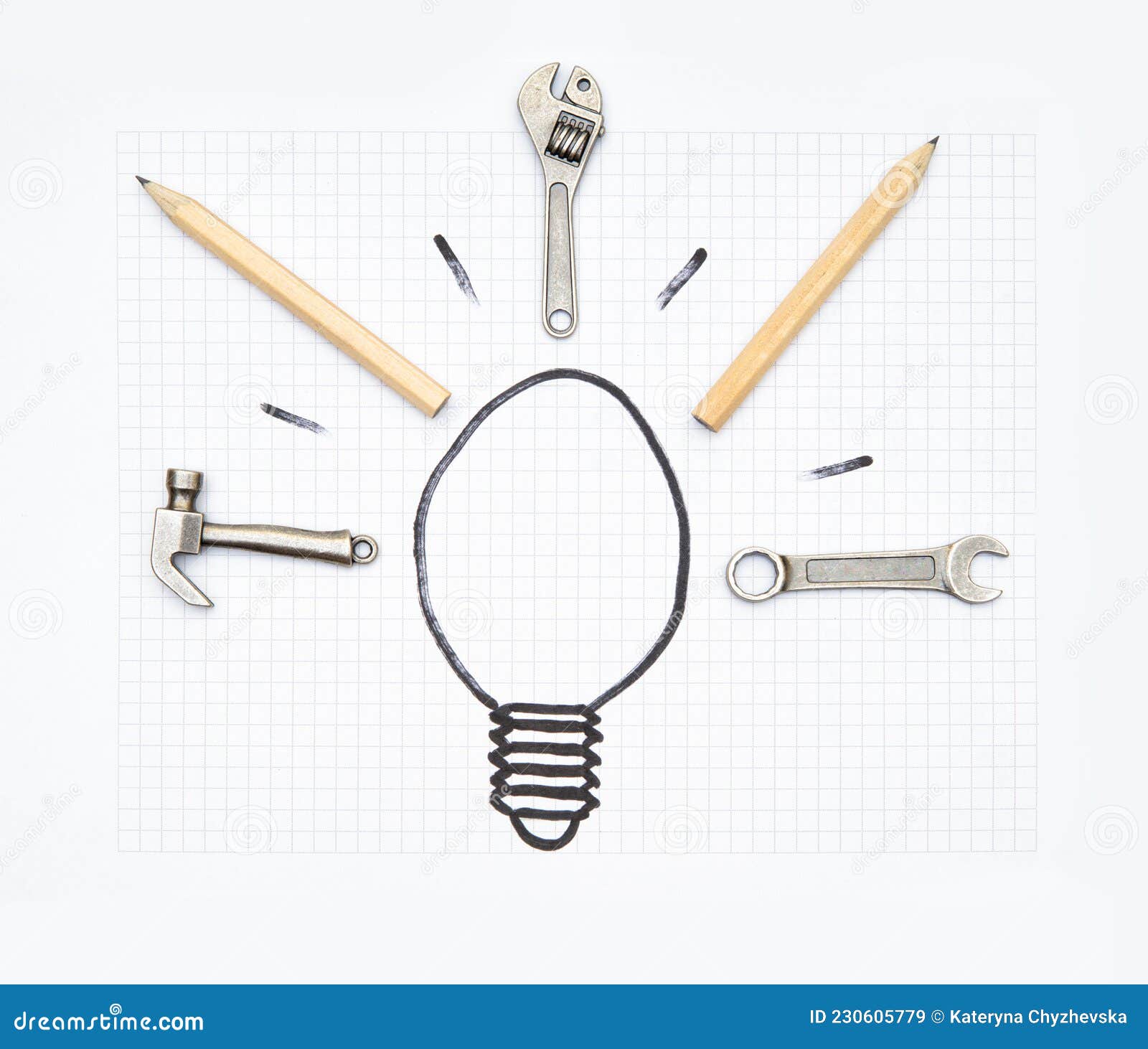 light bulb  with hand tools and pencils