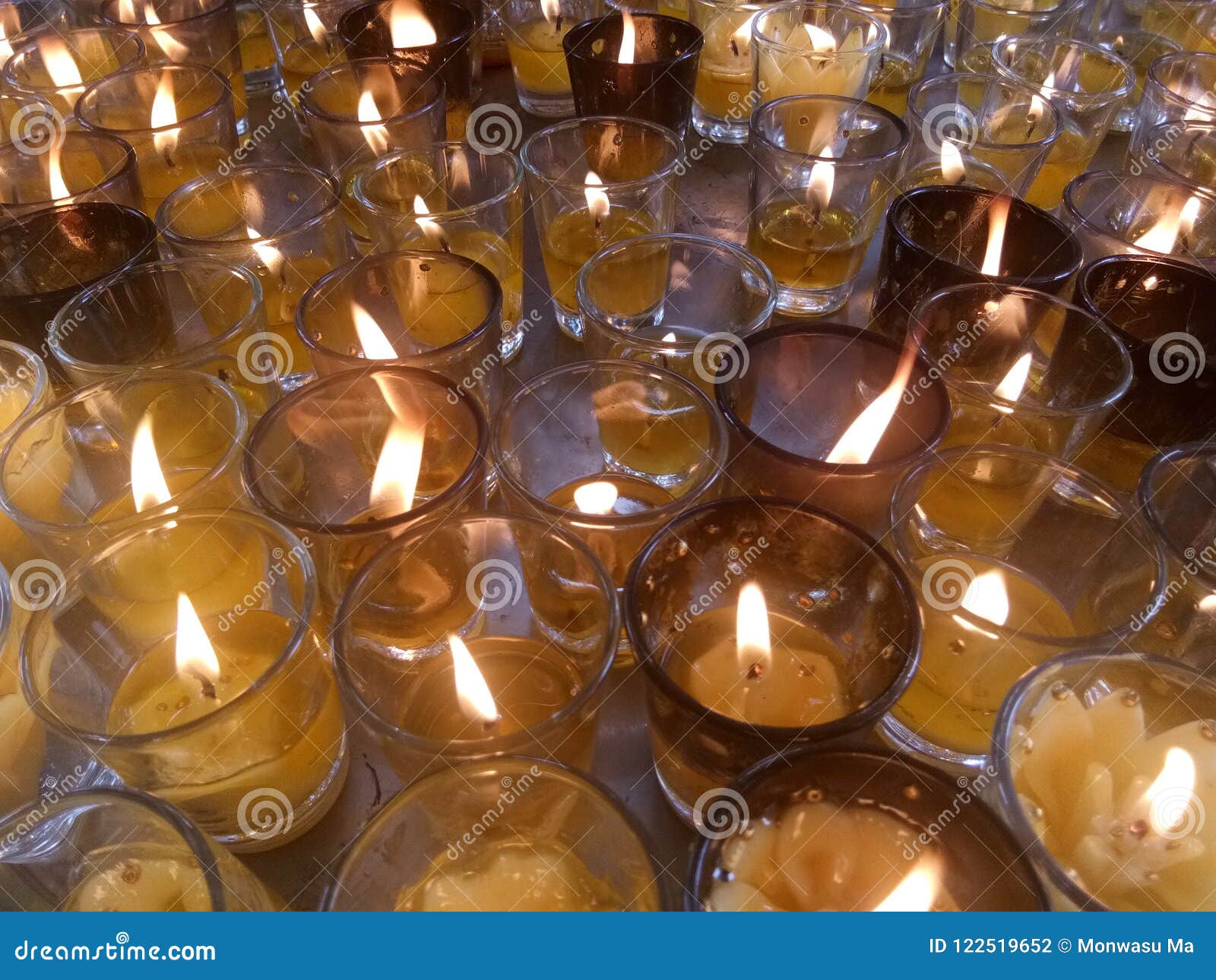 Light of candles in glass stock photo. Image of orenge 122519652