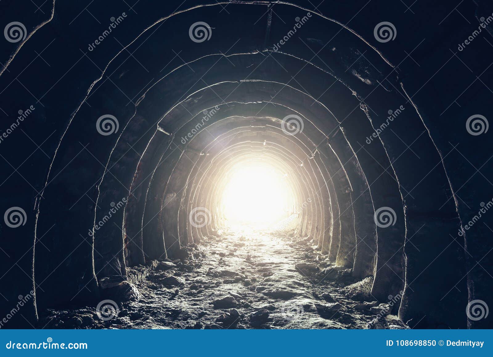 light at the end of dark industrial tunnel, abandoned underground cave or mine, exit or escape to freedom light concept