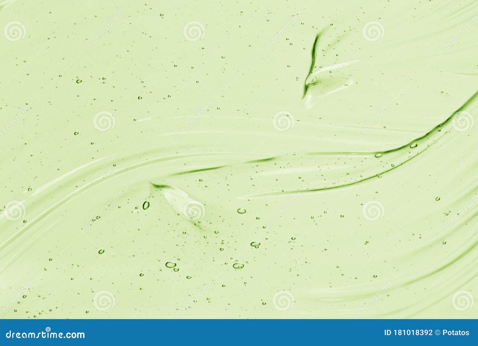 light green serum texture. aloe vera gel background. clear colored liquid cream, face mask smear