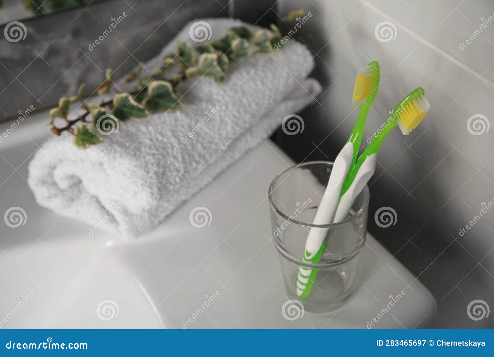 Light Toothbrushes in Glass Holder on Washbasin Stock Image Image of