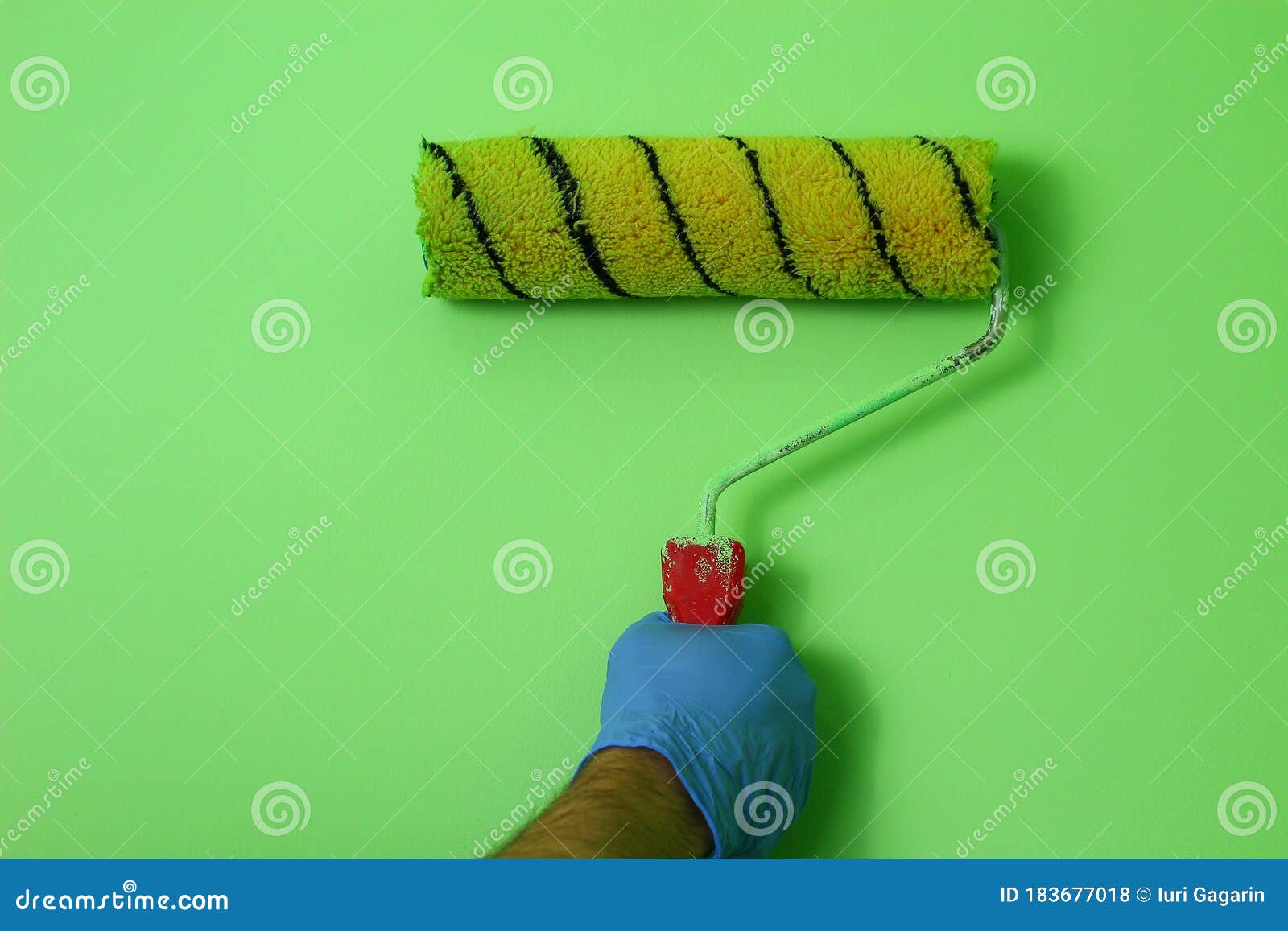 Light Green Wall and Paint Roller Imitation. Home Renovation Stock