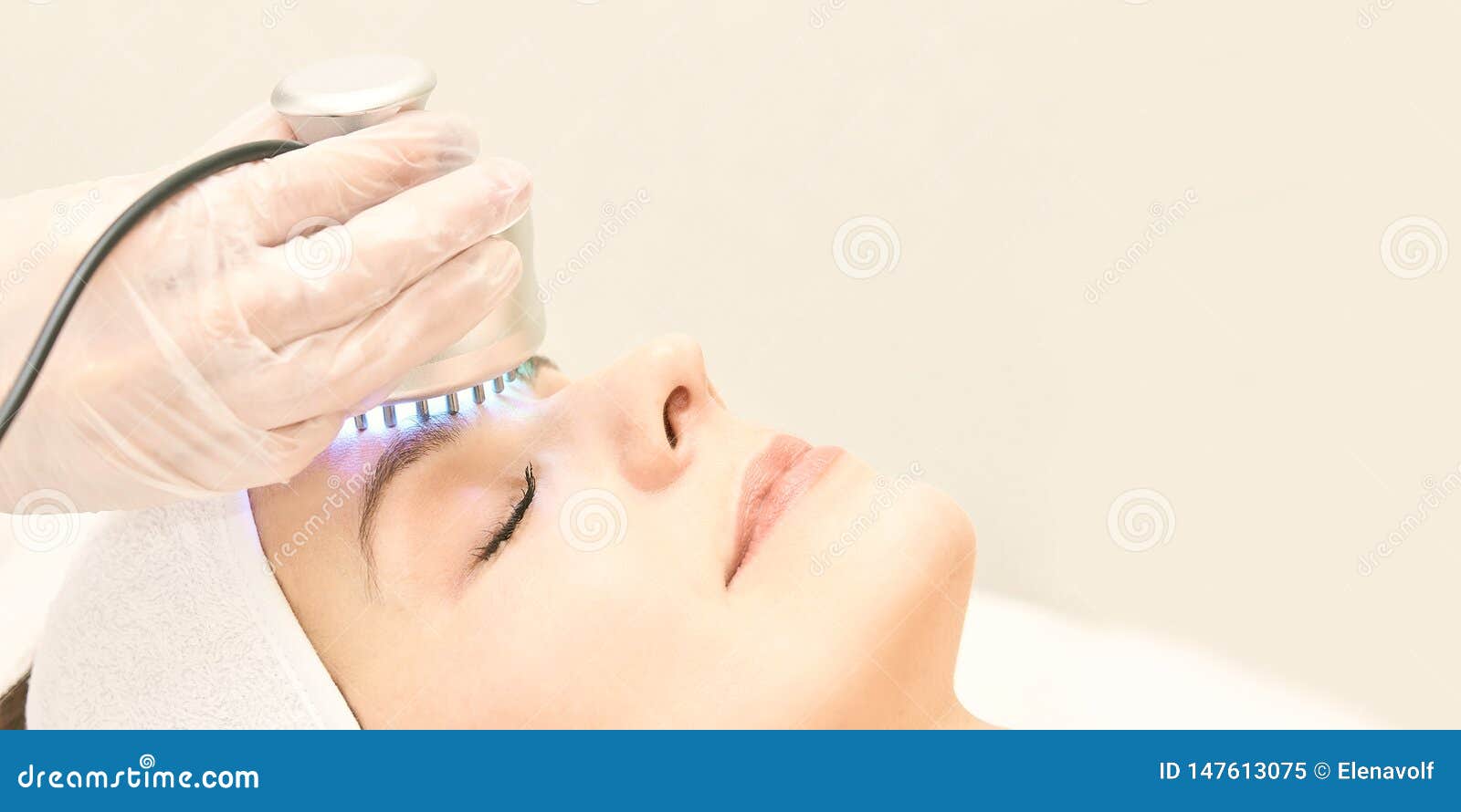 light infrared therapy. cosmetology head procedure. beauty woman face. cosmetic salon device. facial skin rejuvenation