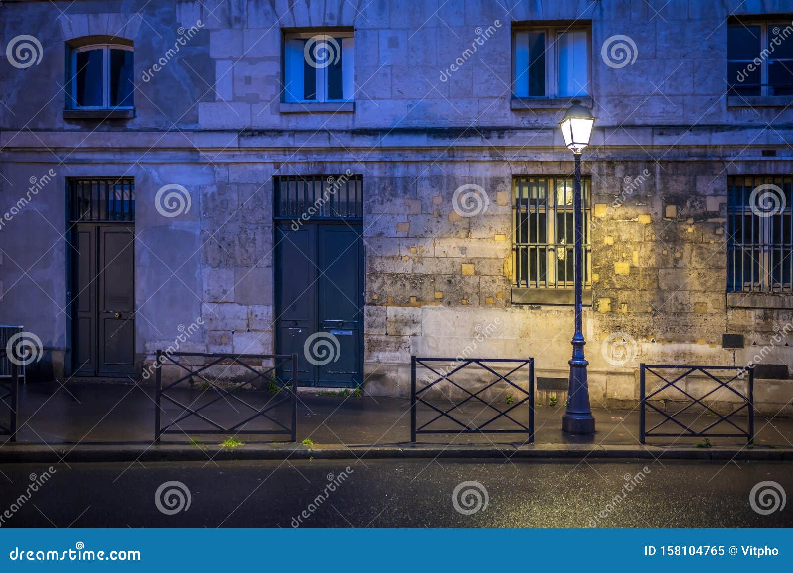 The Light of Lonely Street Lamp on the Evening Street of Paris after
