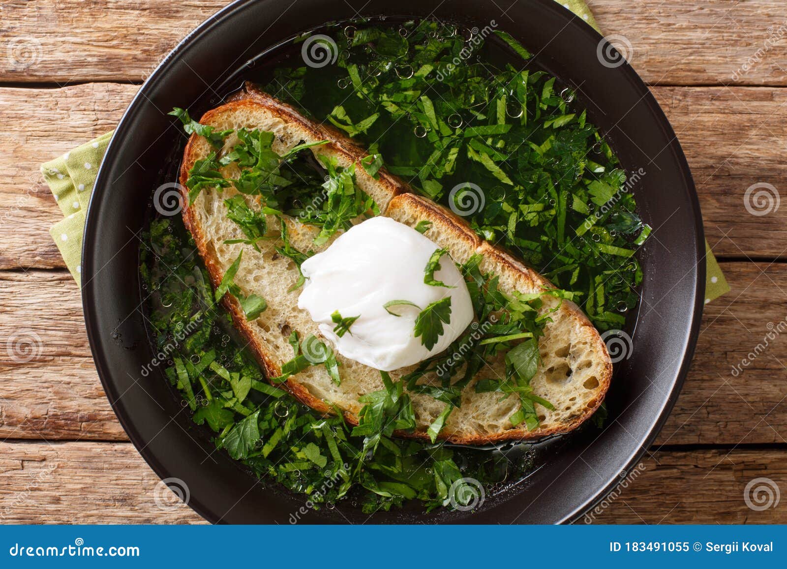 light portuguese green soup acorda with poached bread and egg close-up in a plate. horizontal top view