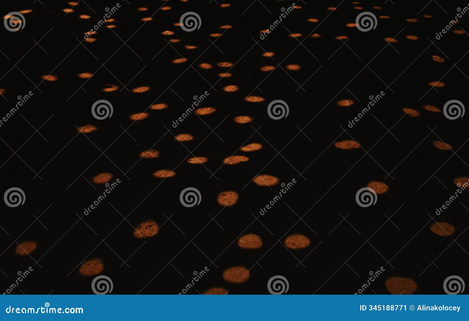 light projection of circles on a brick wall and road in the dark on the street in a chaotic manner