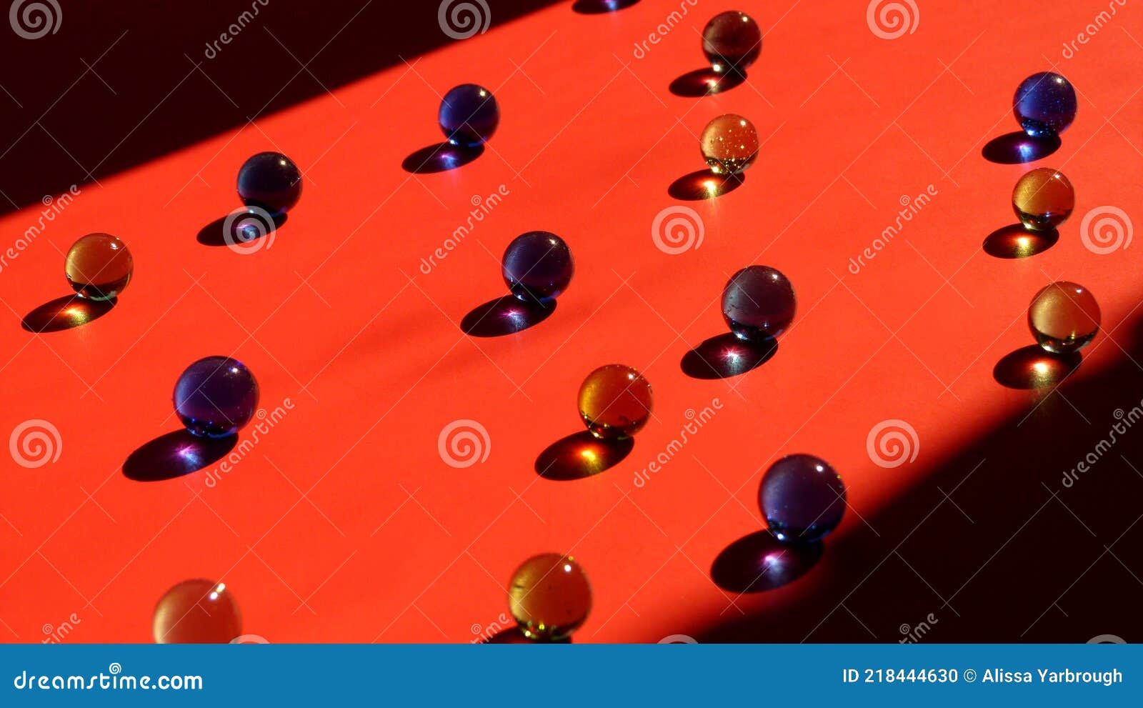 Light Shining on Glass Marbles on a Red Surface Stock Photo Image of