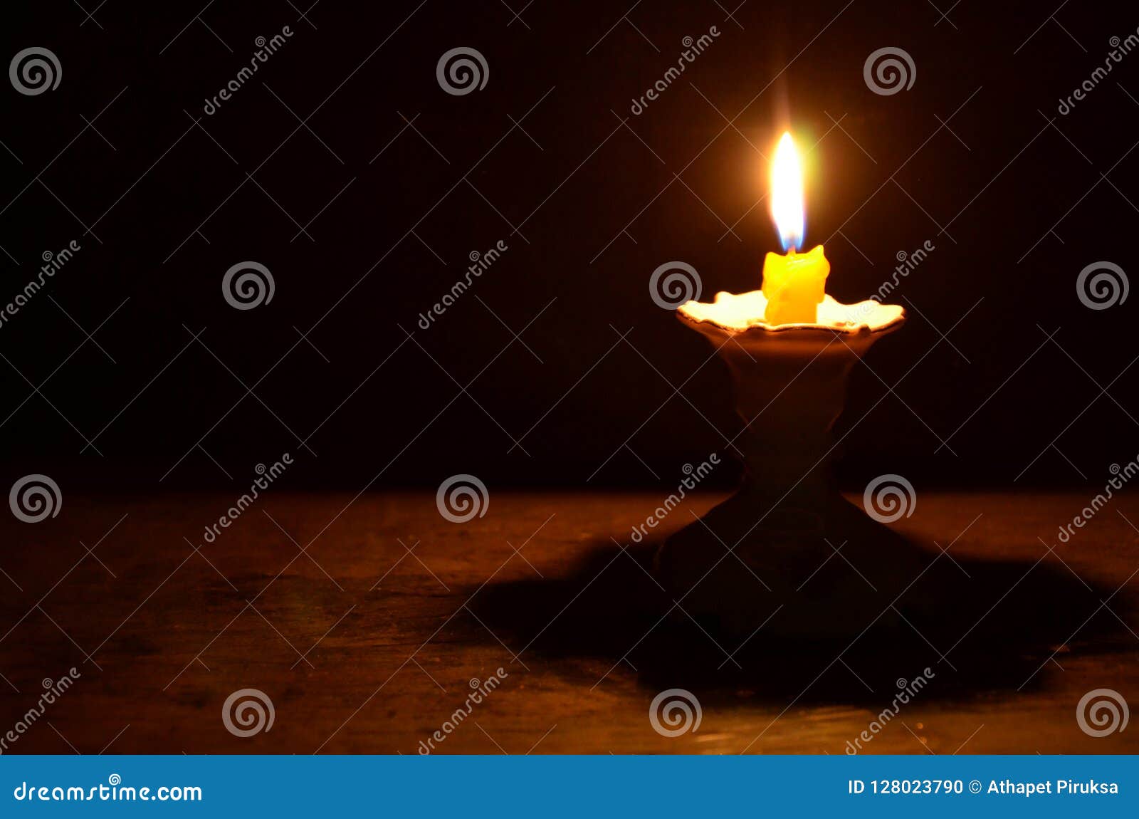 Light of Yellow Candle on the Pedestal in the Night Stock Photo Image