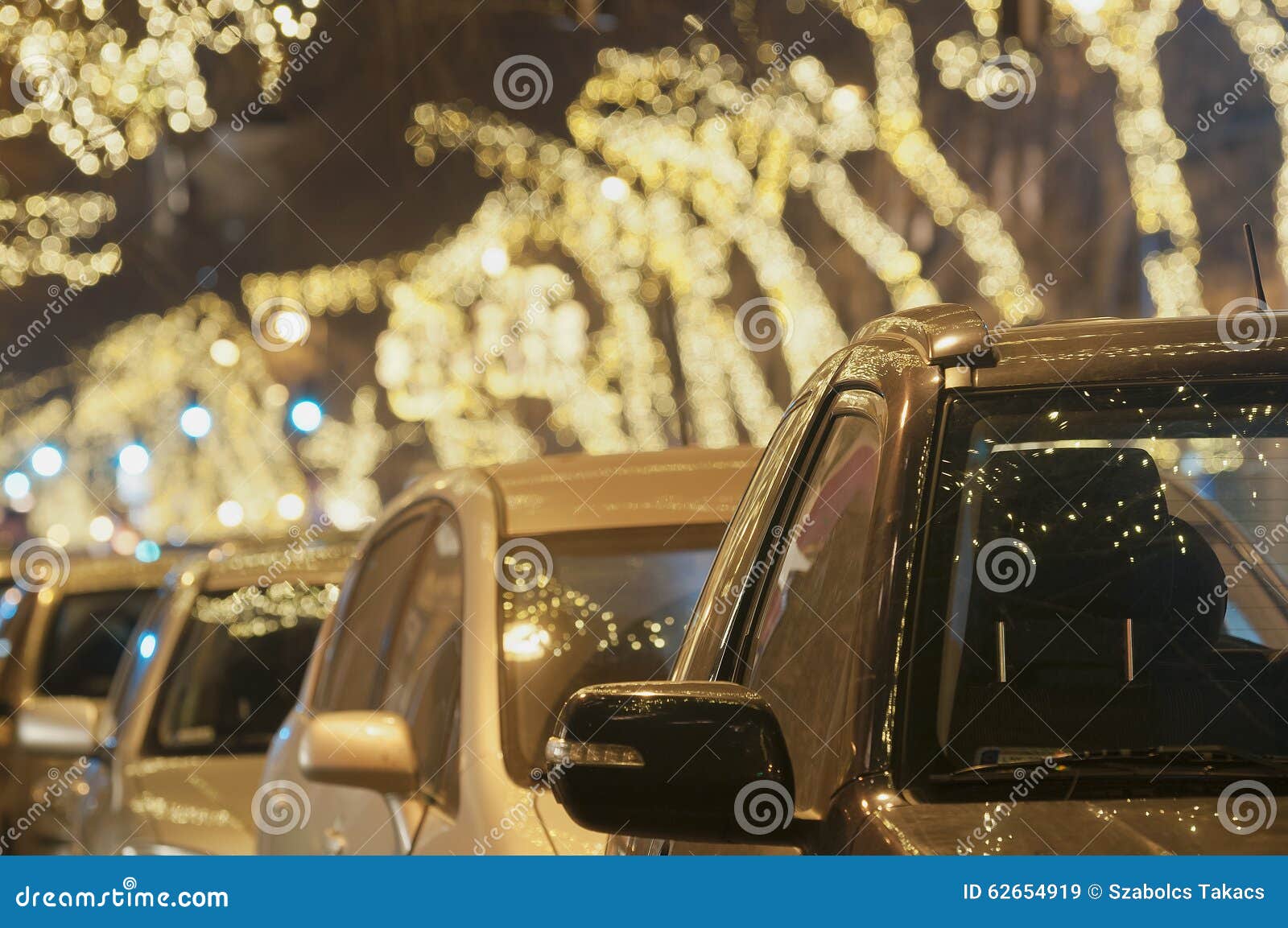 Light String Decorated Trees with Cars at Christmas Time Stock Image