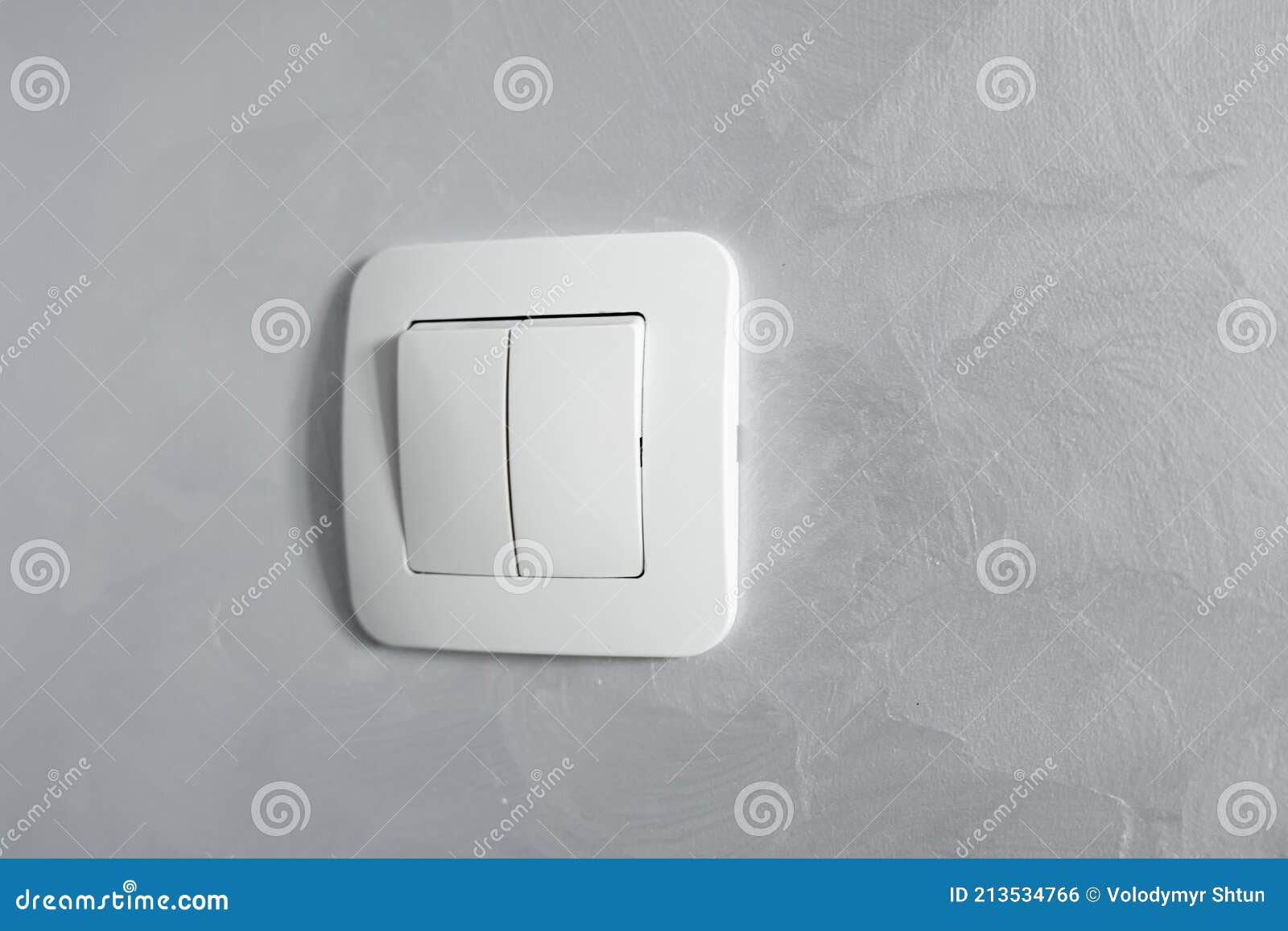 Light Switch, a Plastic Mechanical Switch of White Color Installed on a