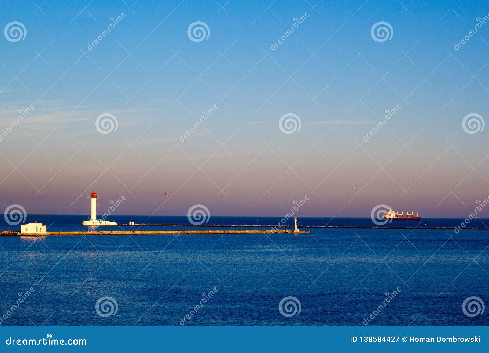Lighthouse and Cargo Ship Leaving a Harbor in the Evening Stock Image Image of regatta, list