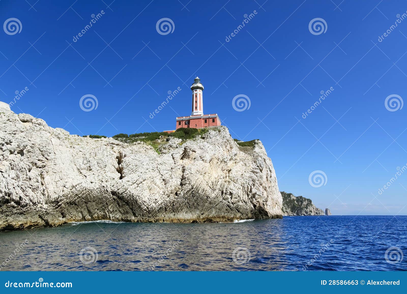 lighthouse on cliff, punto carena - capri island - italy