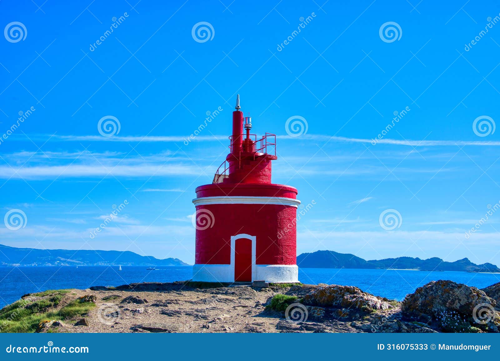 lighthouse in landscape. the iconic red lighthouse at punta robaleira. cabo home, cangas, galicia, spain