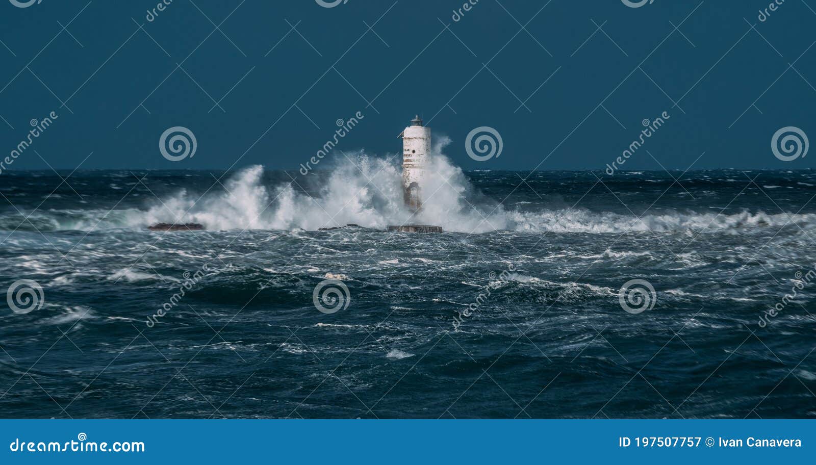 the lighthouse of the mangiabarche shrouded by the waves of a mistral wind storm