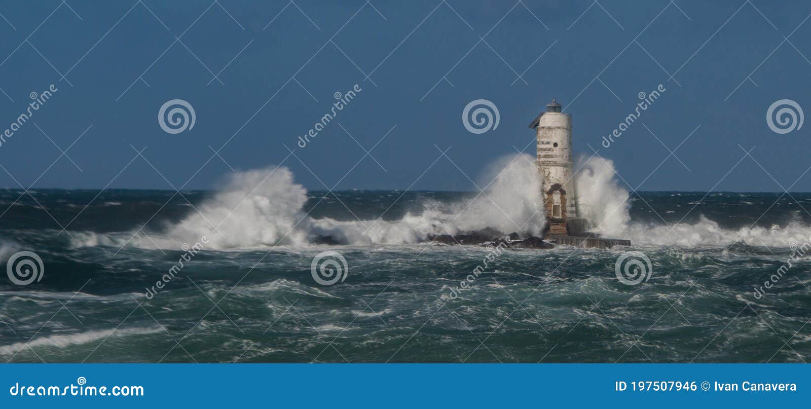 the lighthouse of the mangiabarche shrouded by the waves of a mistral wind storm