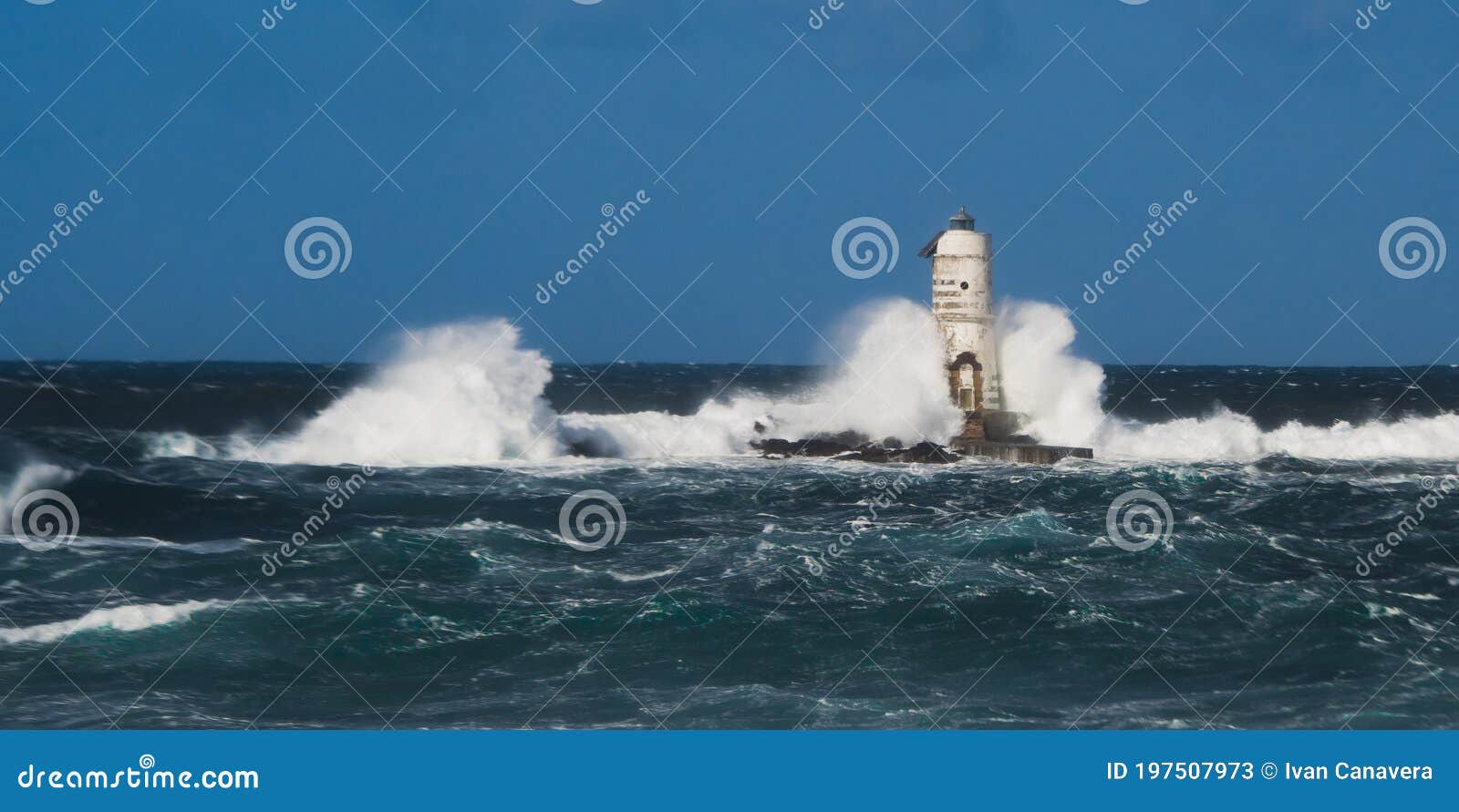 the lighthouse of the mangiabarche shrouded by the waves of a mistral wind storm