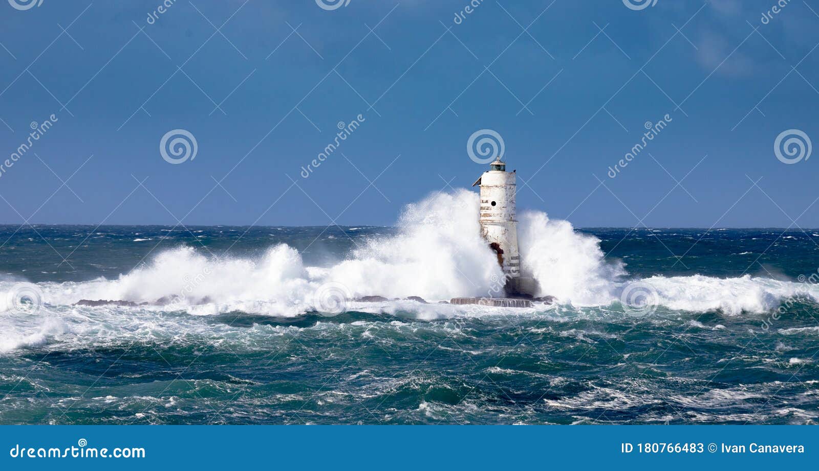 the lighthouse of the mangiabarche shrouded by the waves of a mistral wind storm