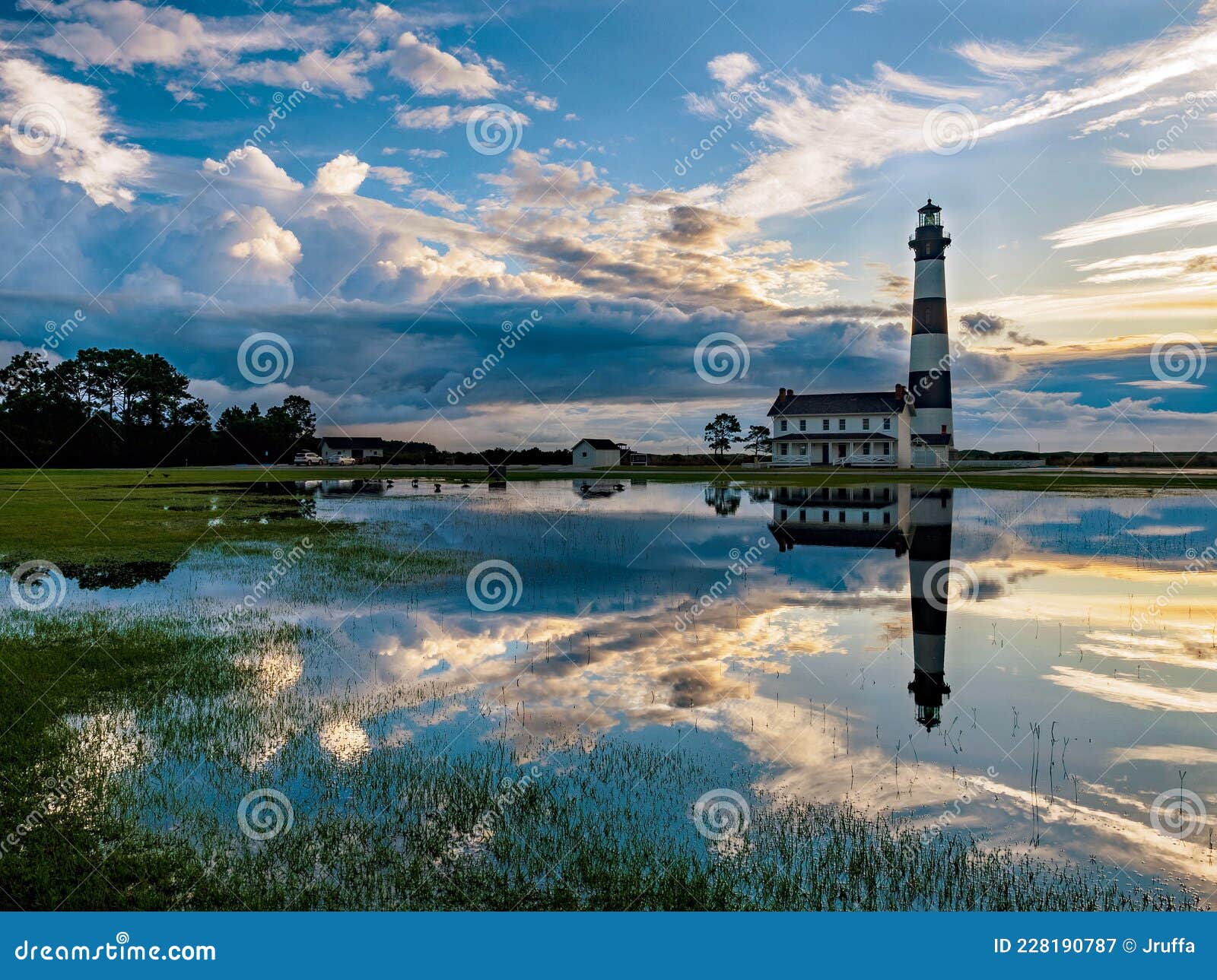 lighthouse reflection in marshland water