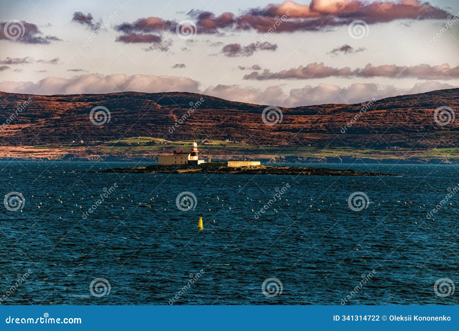 a lighthouse stands on a small island, surrounded by a blue sea. the background features rolling hills and a sky filled with light