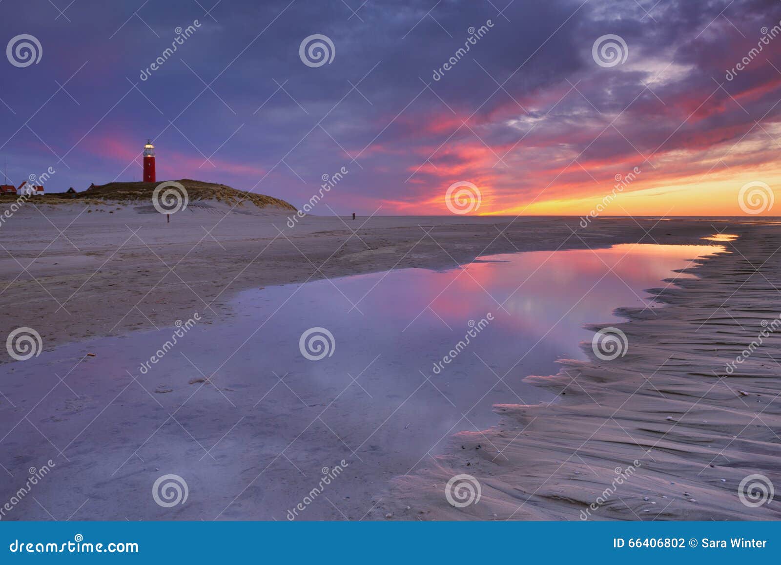 lighthouse on texel island in the netherlands at sunset