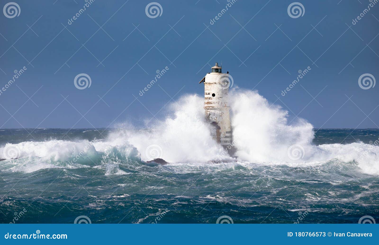 the lighthouse of the mangiabarche shrouded by the waves of a mistral wind storm