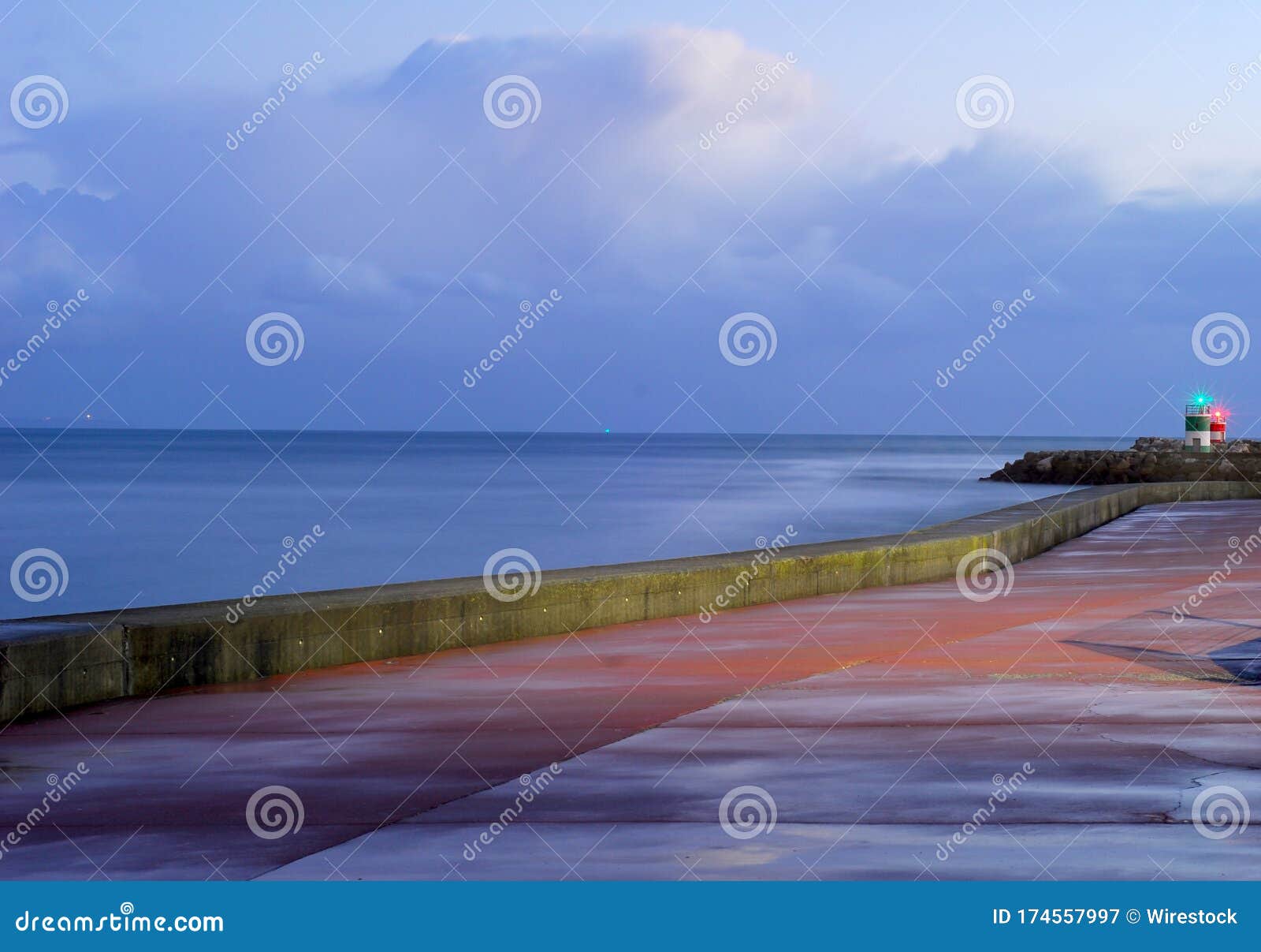 Lighthouses Surrounded By The Sea Under A Cloudy Sky In The Evening