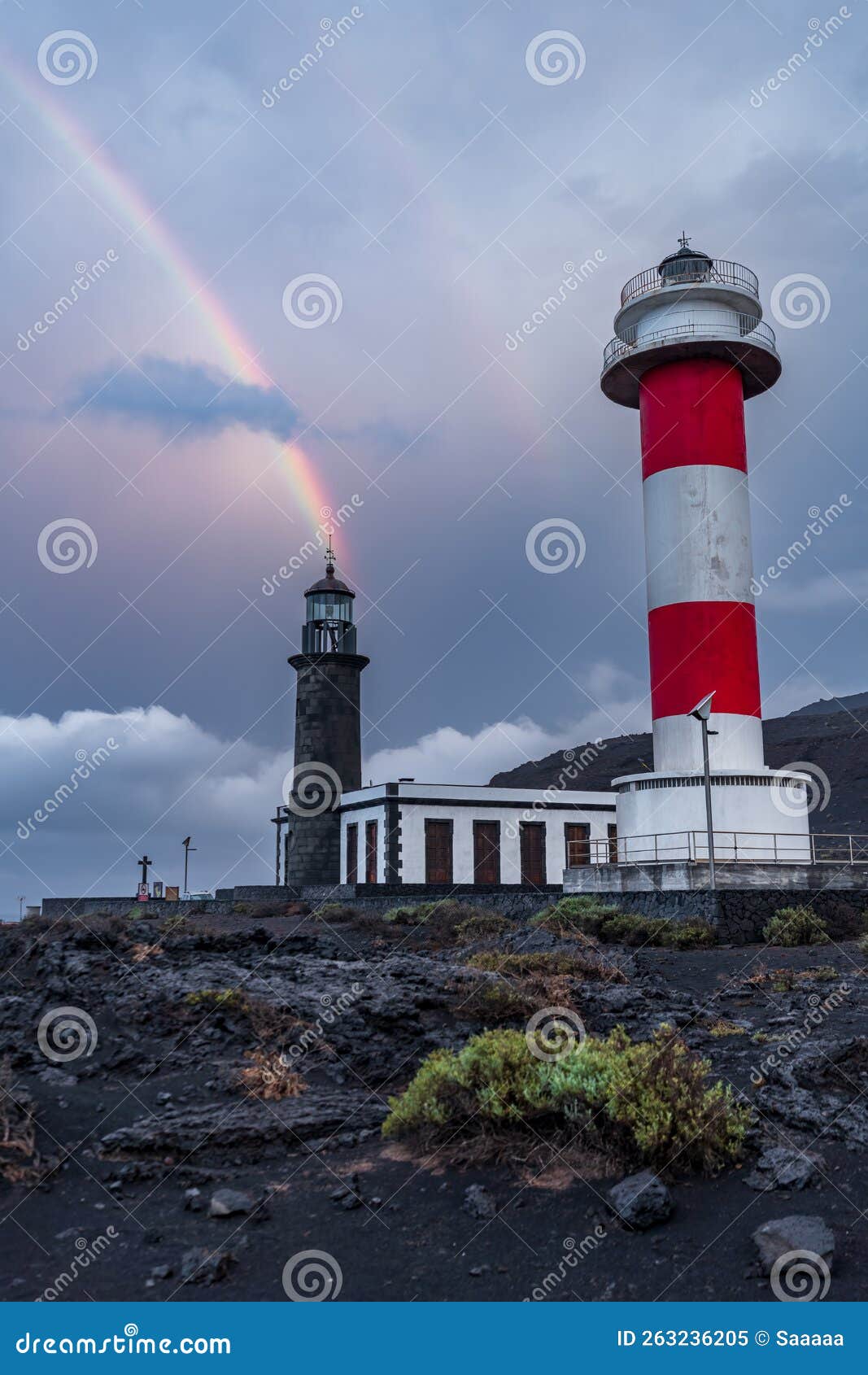 lighthouses under the rainbow and stormy clouds
