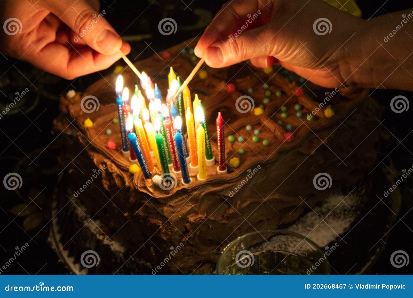 Lighting Candles on a Birthday Chocolate Cake Stock Image Image of