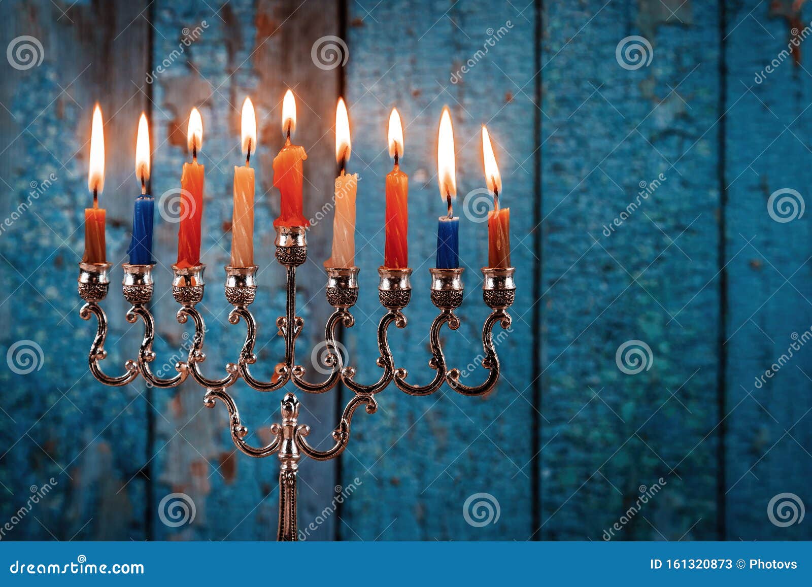 lighting candles in menorah for hanukkah