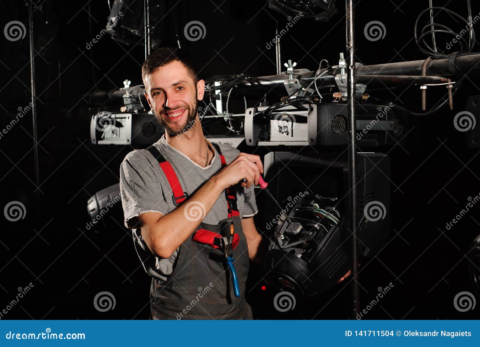 The Lighting Engineer Repairs the Light Device on Stage. Stock Photo