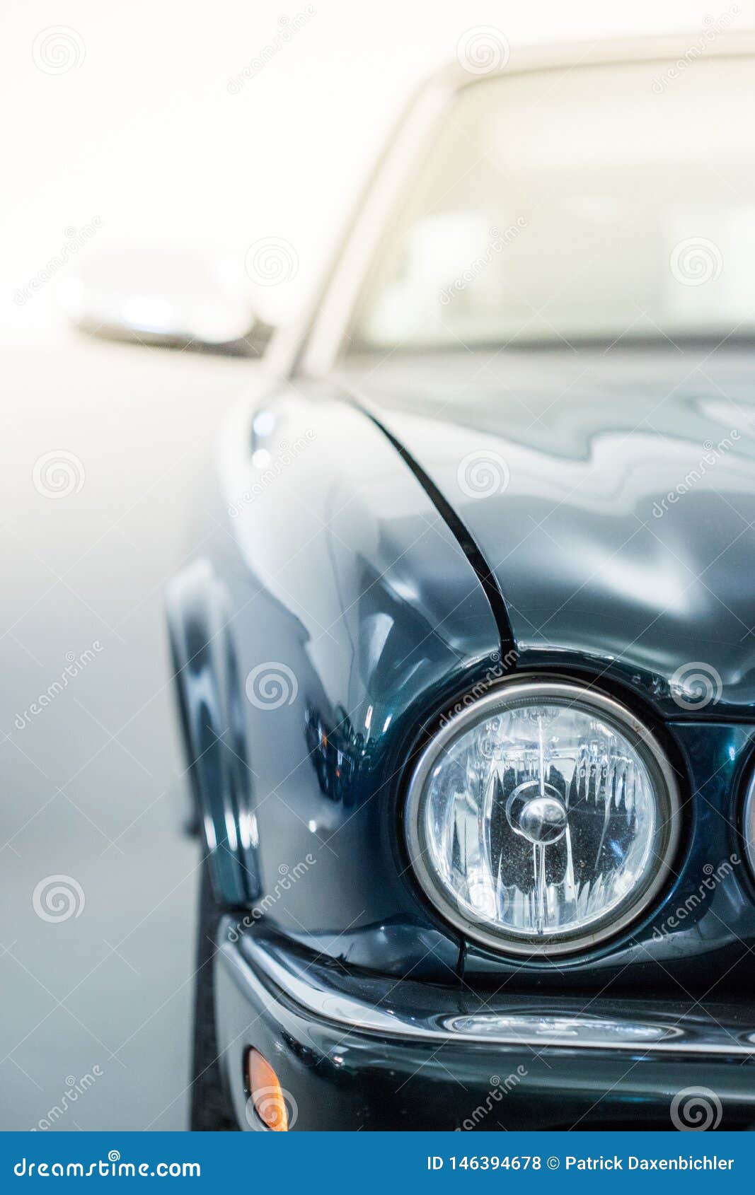 circle lights of a polished green vintage car