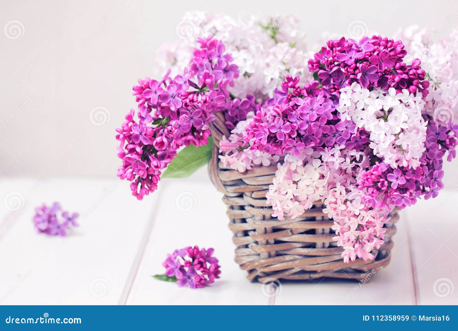 lilac flowers bouquet in wisker basket