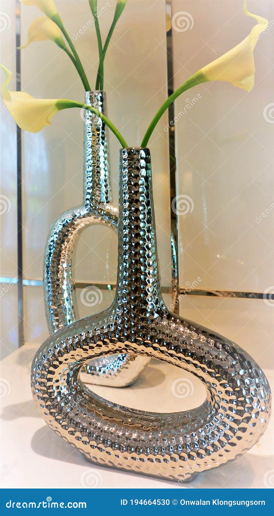 Lilies are Placed in Tall and Curved Vases. Stock Photo Image of