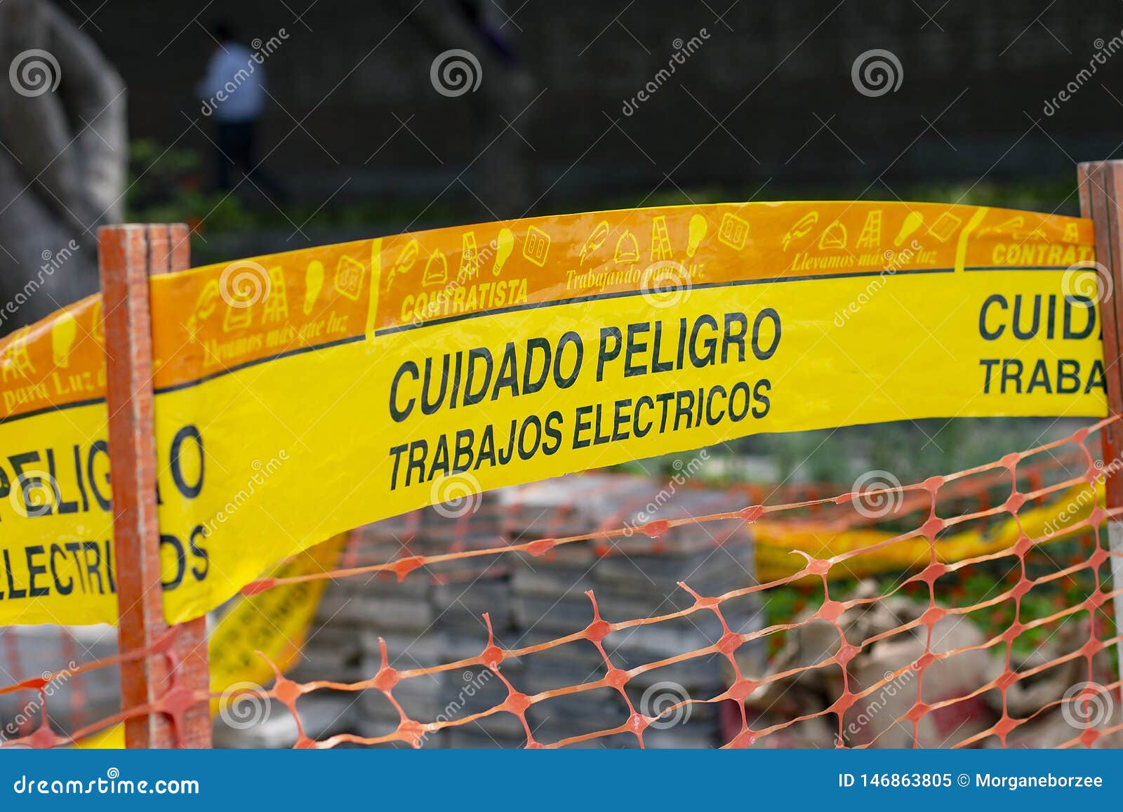 yellow tape marked caution `cuidado` in spanish