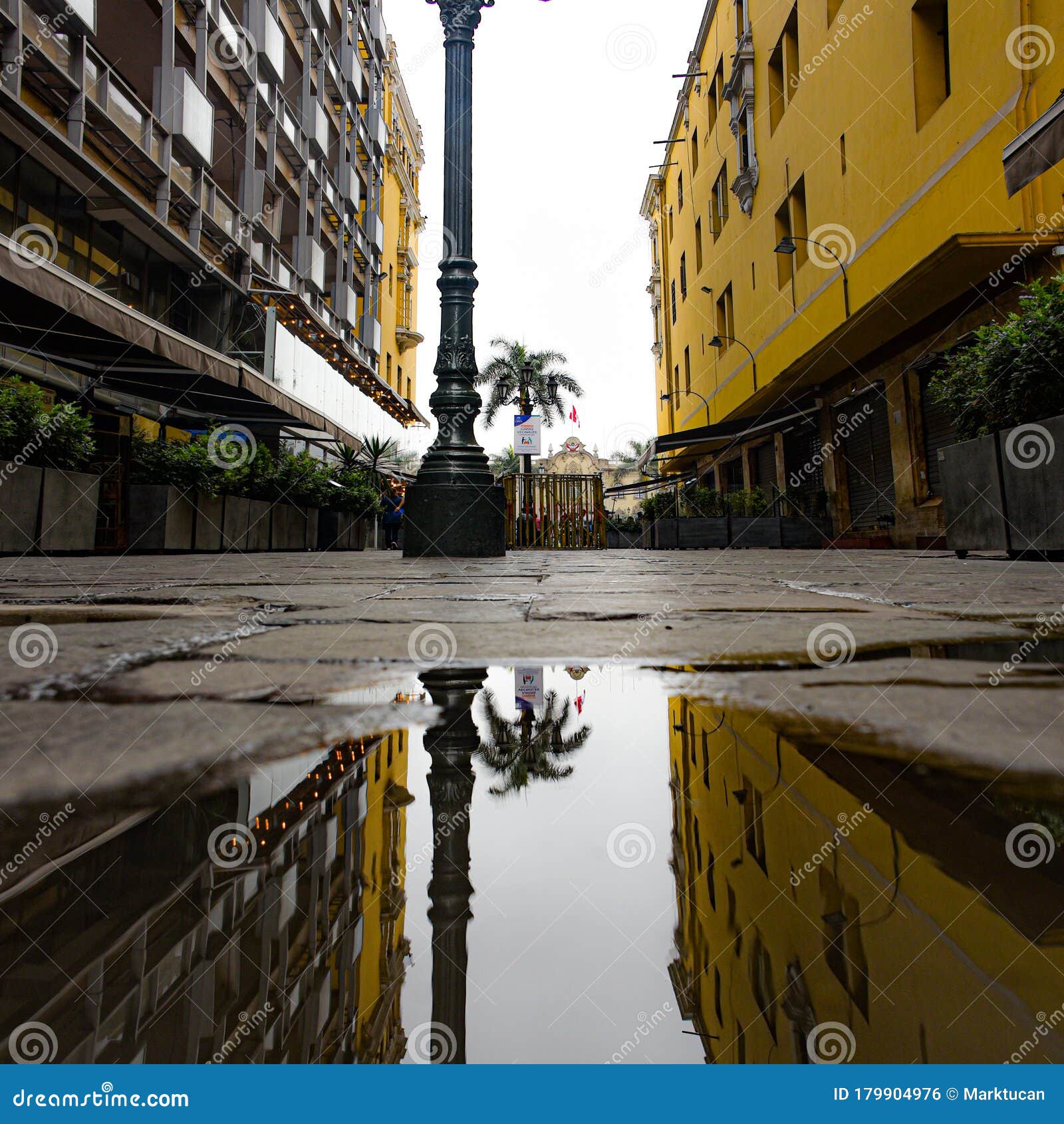 reflections of the plaza de armas in the historic center of lima, peru