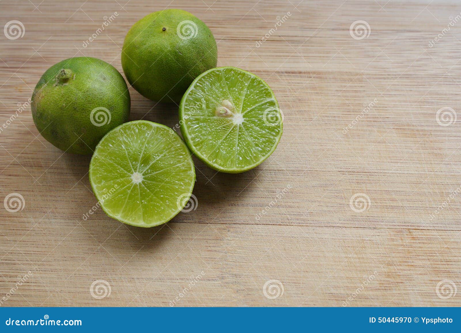 Limes on a cutting board stock photo. Image of organic 50445970