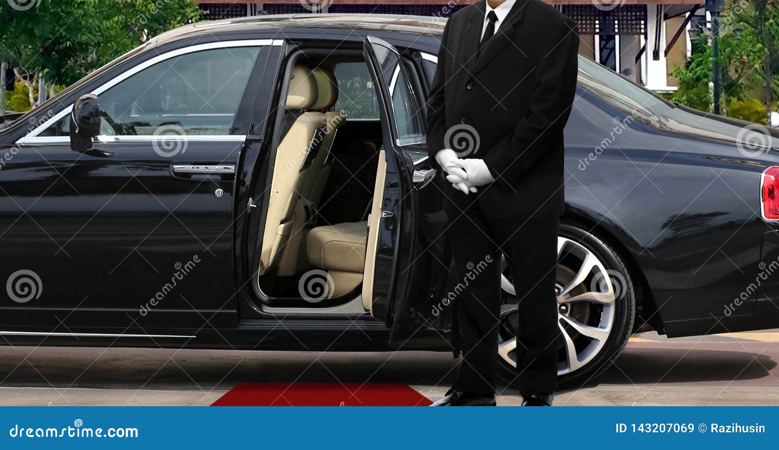 limo driver standing next to opened car door with red carpet