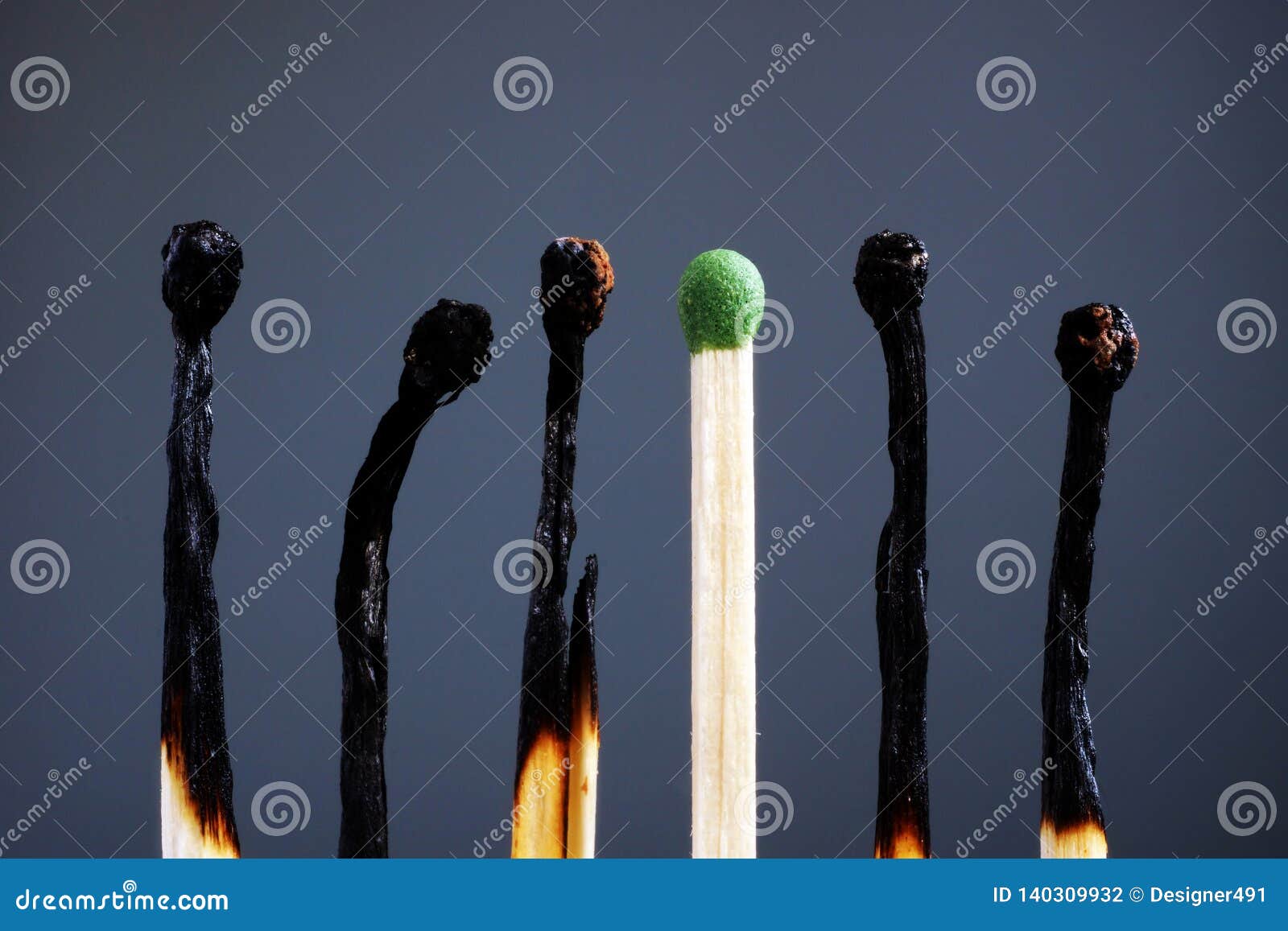 line of burnt matches and one brand new. individuality, leadership, burnout at work and energy