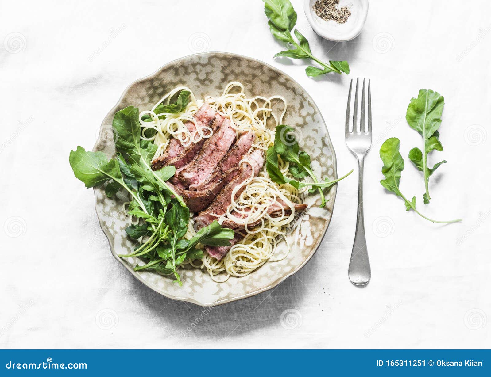 Linguine Pasta with Sliced Beef Steak and Rocket Salad on a Light